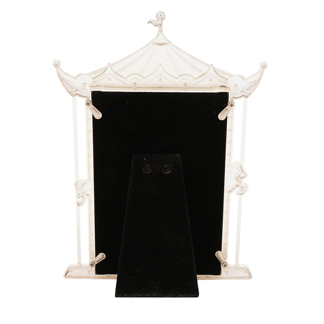Decorative white pagoda-style picture frame with a black interior on a white background