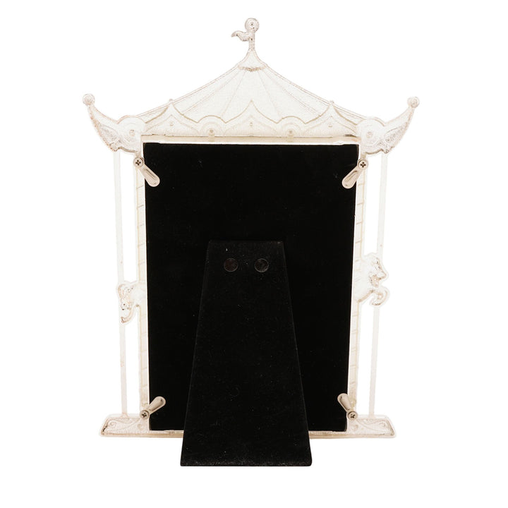 Decorative white pagoda-style picture frame with a black interior on a white background