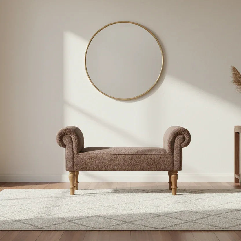Brown upholstered bench in a room with a round mirror on the wall.