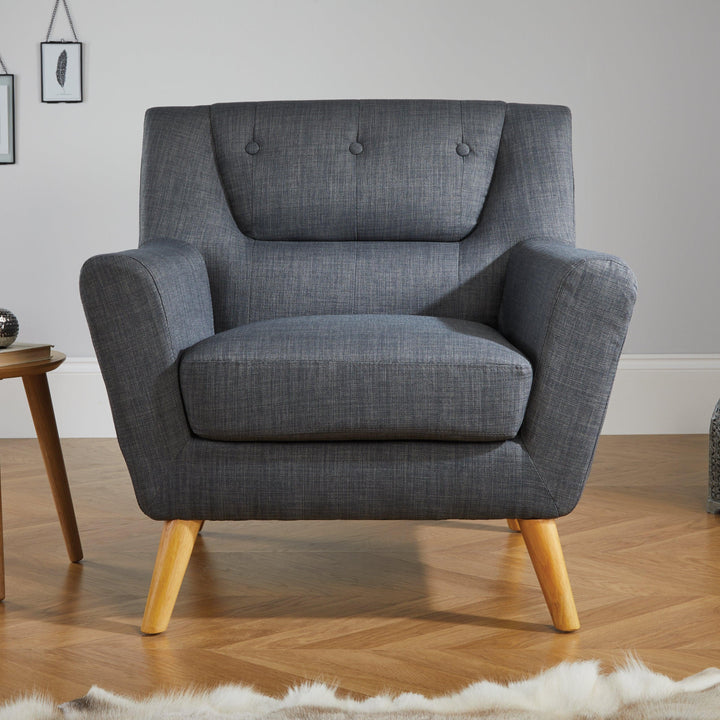 Gray armchair in a room with wooden floor and side table