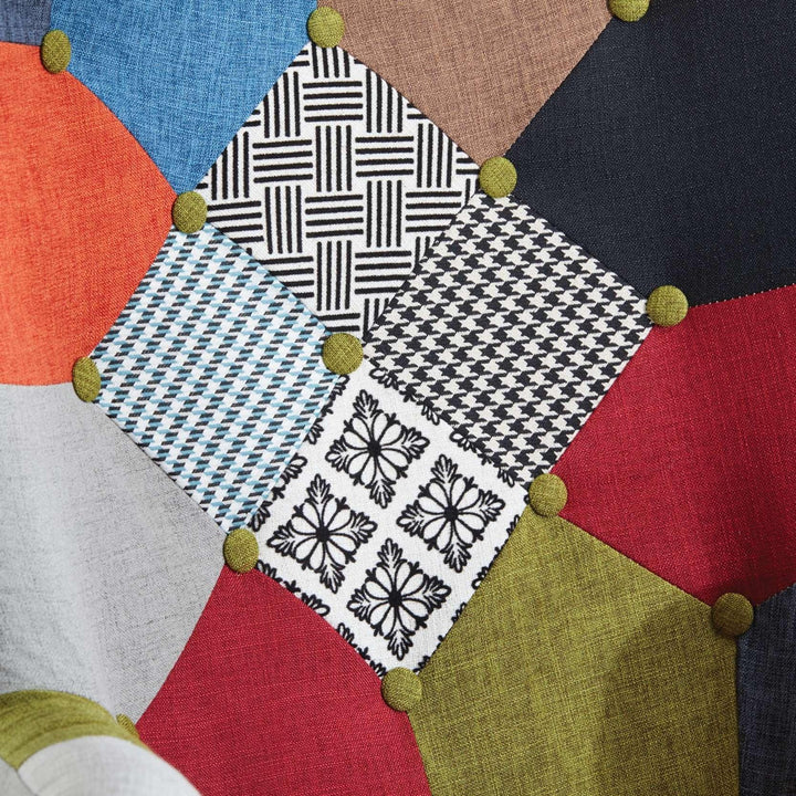 Patchwork fabric with geometric patterns and colorful buttons on a neutral background