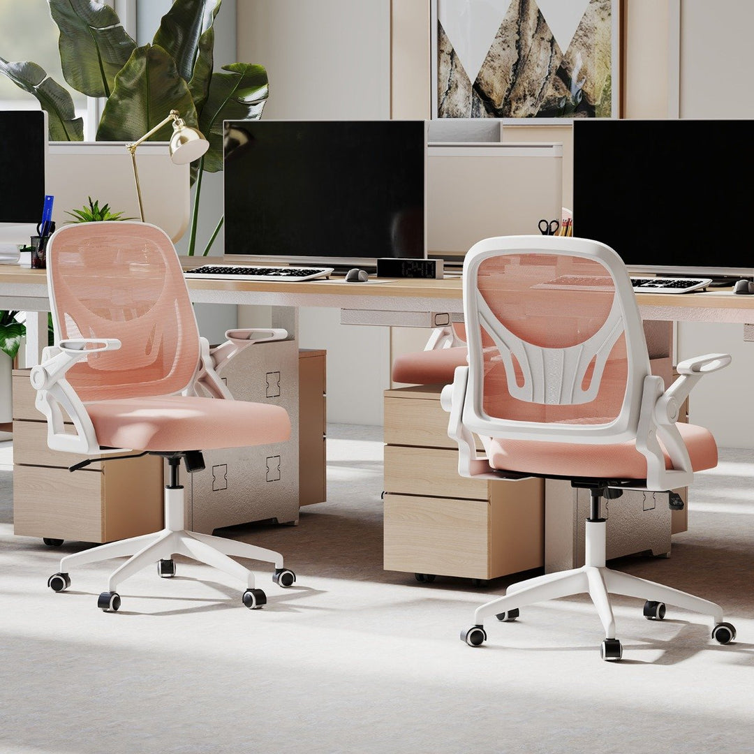 Pink mesh ergonomic office chair in modern office setting